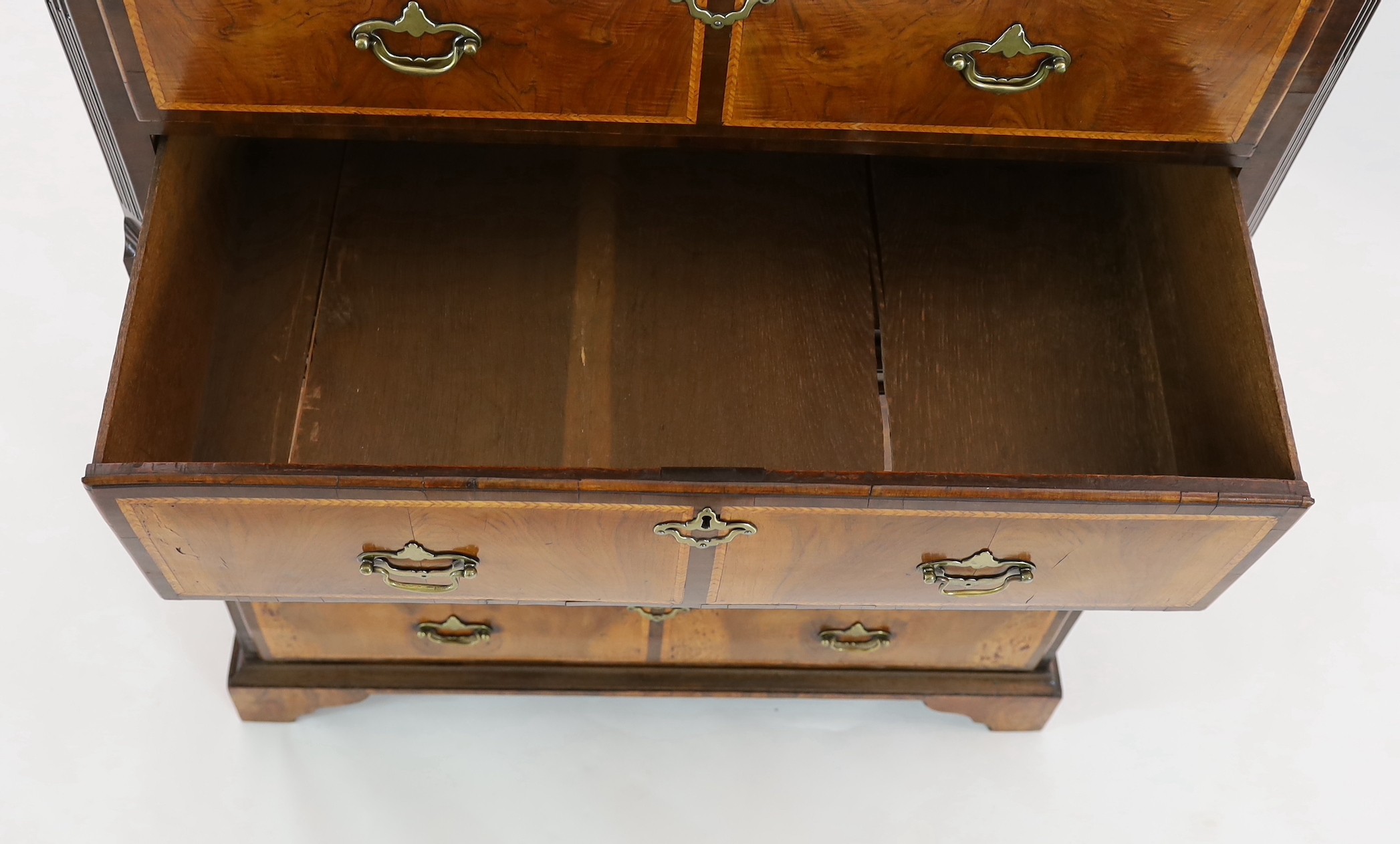 A George II featherbanded walnut chest on chest, width 100cm, depth 51cm, height 165cm